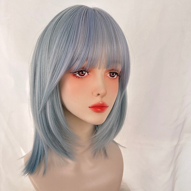 Mannequin head with light blue wig on a white background