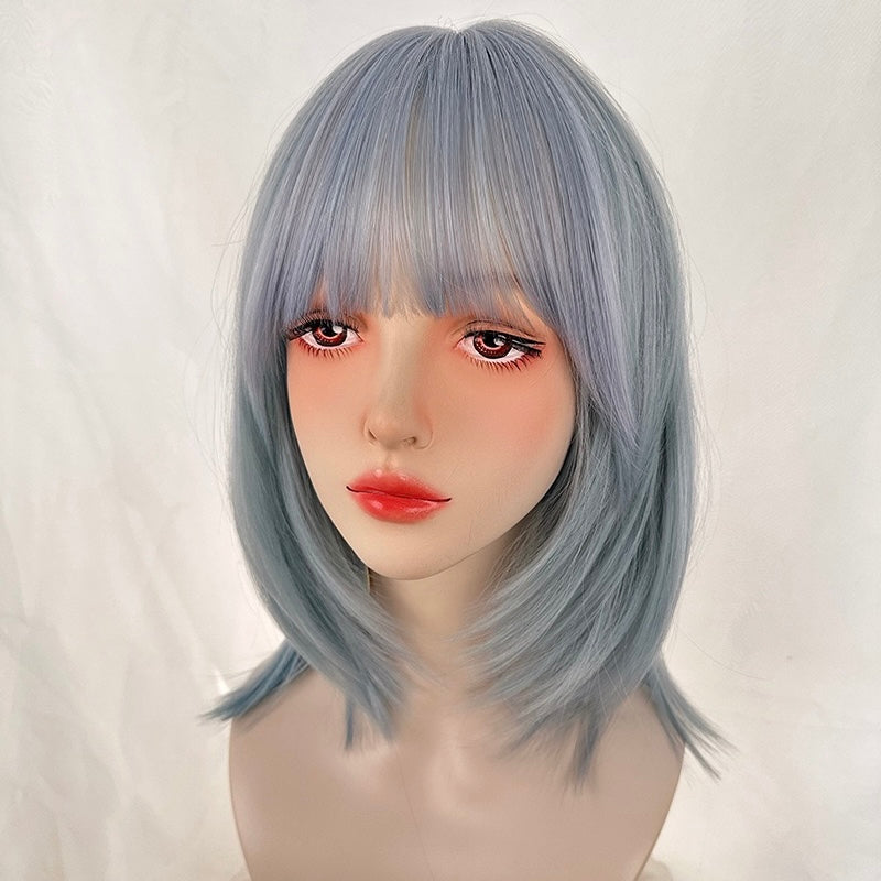 Mannequin head with light blue wig on a white background