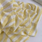 Yellow and white striped fabric on a white background