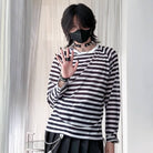 Person wearing a black and white striped shirt with a plain background