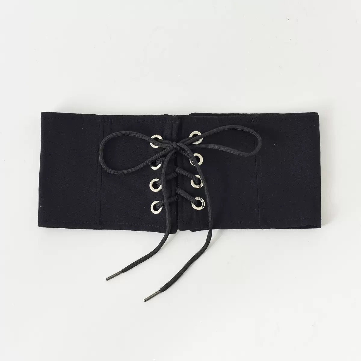 Black lace-up top on a white background