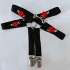 Black garters with red rose decorations on a white background