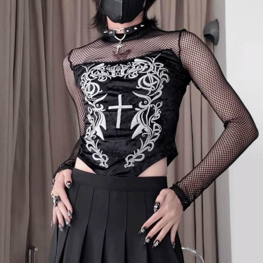 Person wearing a black outfit with fishnet sleeves and decorative white patterns.