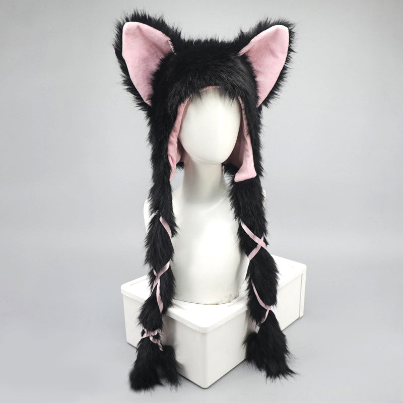 Black and pink fox-like hat with long braided hair on a mannequin head against a gray background