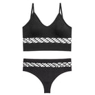 Black sexy cutout bra and panty set with lattice detailing on a white background