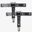 Black leather thigh garters with metal clasps on a white background
