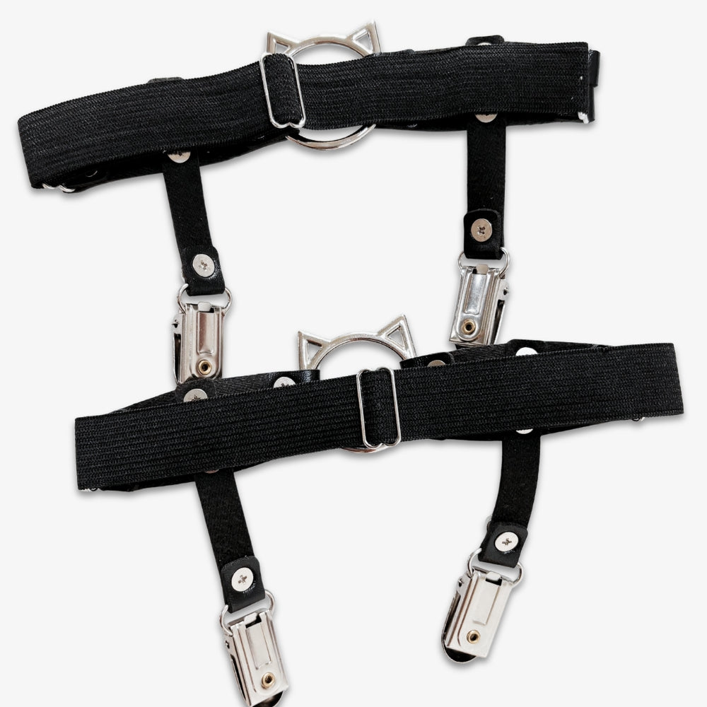 Black leg garters with metal clips on a white background