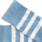 Blue and white striped socks on a light gray background