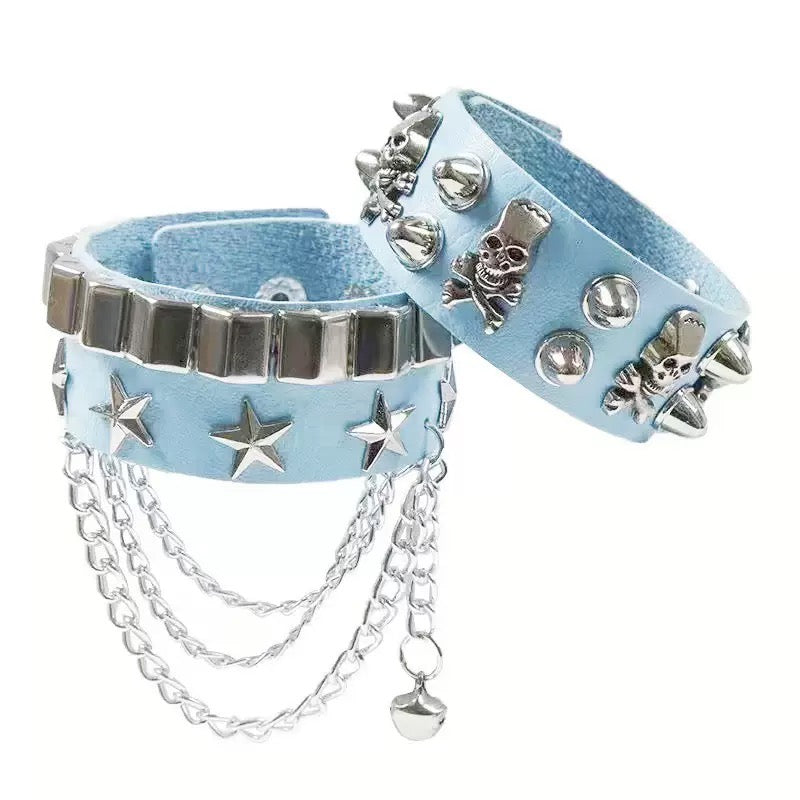 Light blue gothic skull leather bracelets with silver studs and chains on a white background