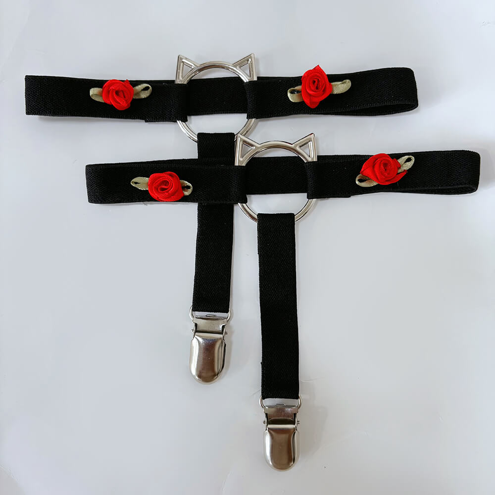 Two black garters with cat ear designs on a white background