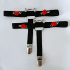 Two black garters with cat ear designs on a white background