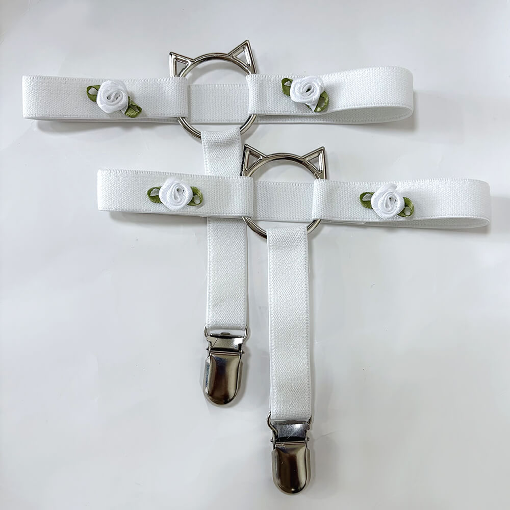 Two white cat-shaped garters on a white background