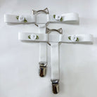 Two white cat-shaped garters on a white background