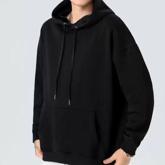 Black hoodie worn by a person on a light gray background