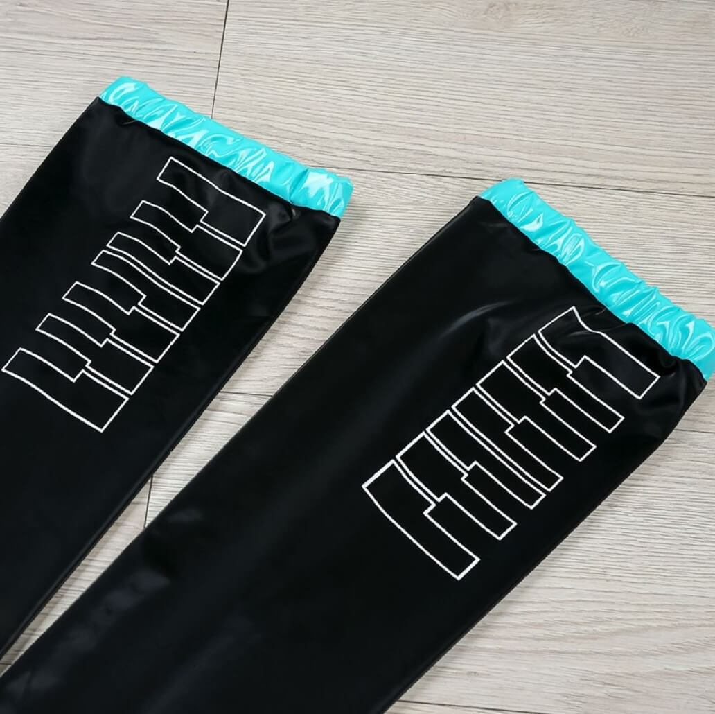 Black cosplay leather thigh highs on a wooden floor