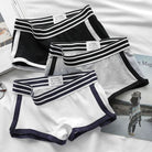 Three pairs of femboy's underwear with striped edges on a white surface.
