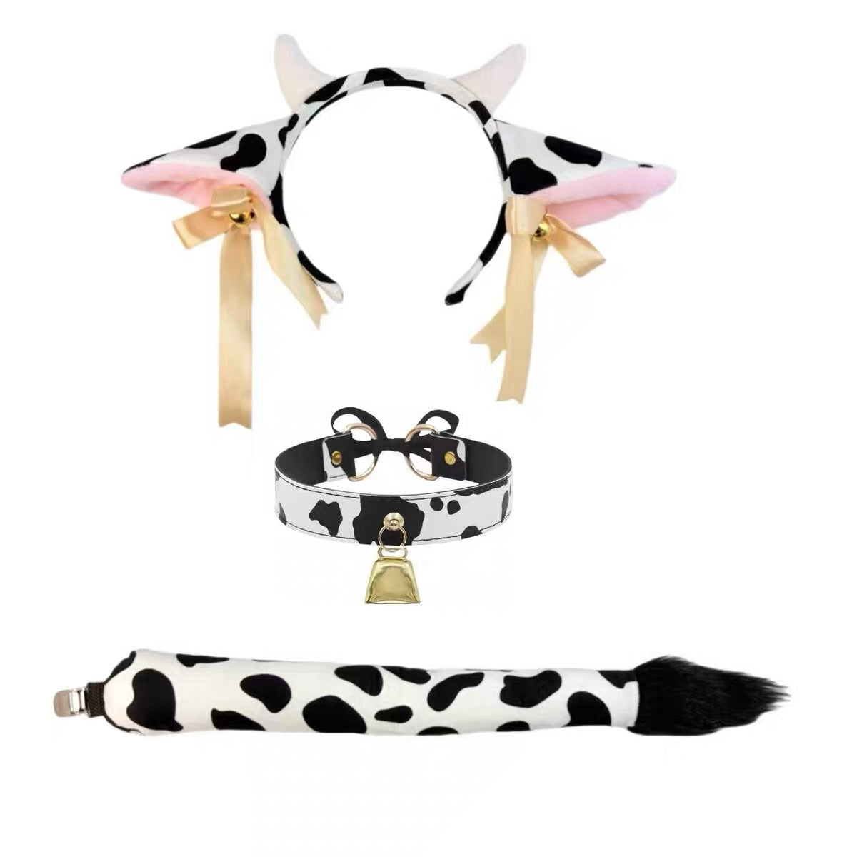 Cow-themed costume accessory set featuring a black and white spotted headband with pink inner ears and gold ribbons, a matching collar with a bell, and a tail with a black-and-white spotted pattern and black tip.
