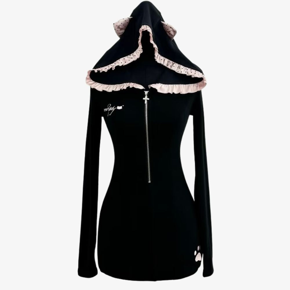 A black long-sleeve hooded dress with a front zipper, featuring a ruffled light pink hood trim with cat-ear details and small white paw-print graphics near the chest and hem.