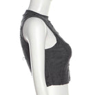 Black distressed denim crop top on a mannequin against a white background