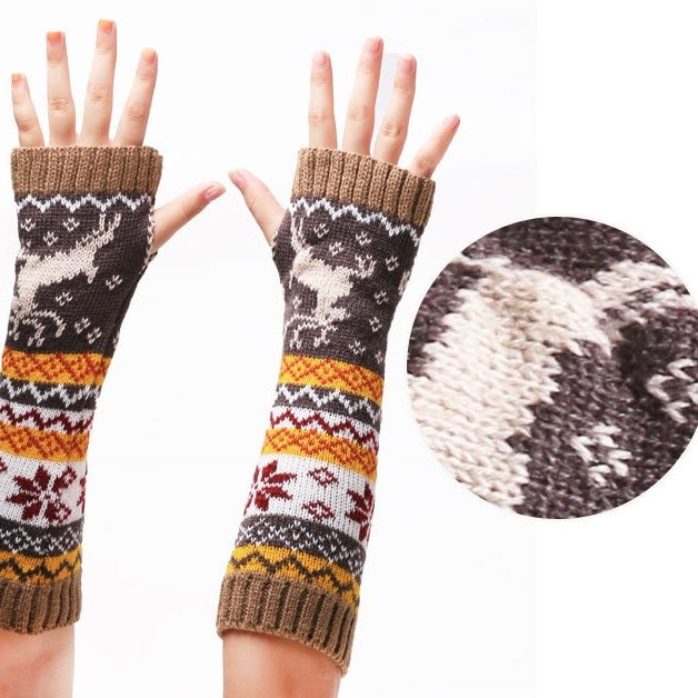Knitted arm warmers with reindeer pattern on a white background