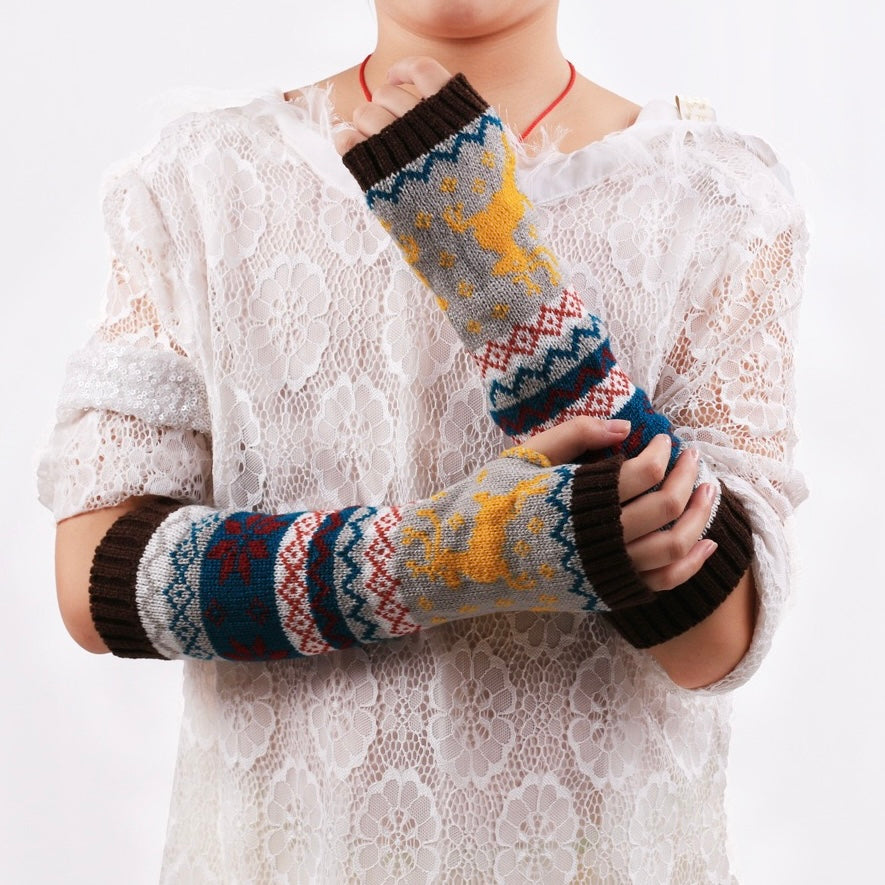 Person wearing elk fingerless knit arm warmers on a white background