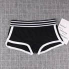 Black boyshorts panty with white trim on a gray textured background