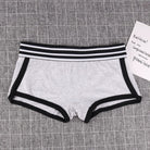 Gray boyshort panty with black trim on a textured gray background