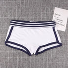 White boyshorts panty with navy trim on a textured gray background