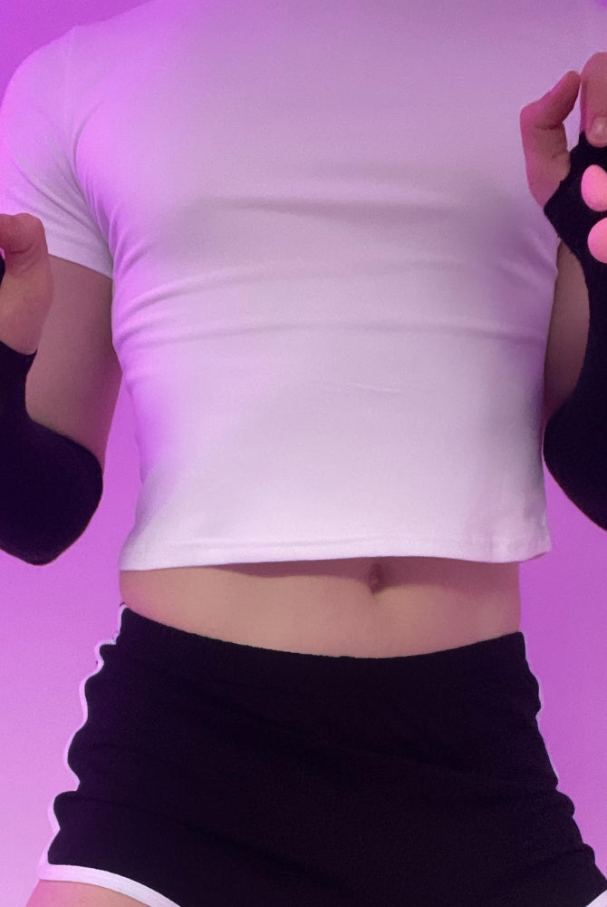 Person wearing black 3d cat paw gloves against a purple background