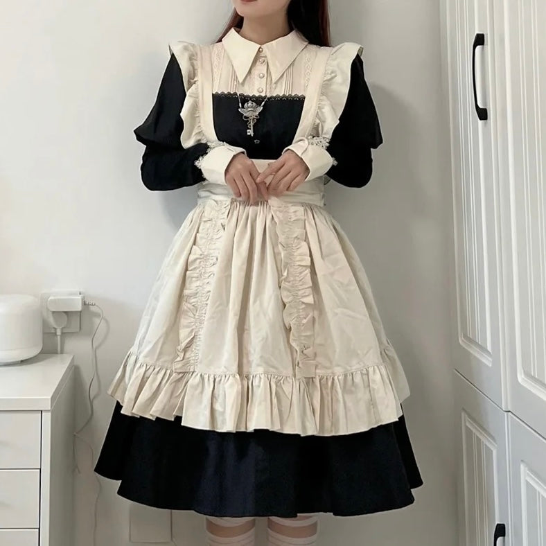 Person wearing a black and white dress with ruffled details in a room.