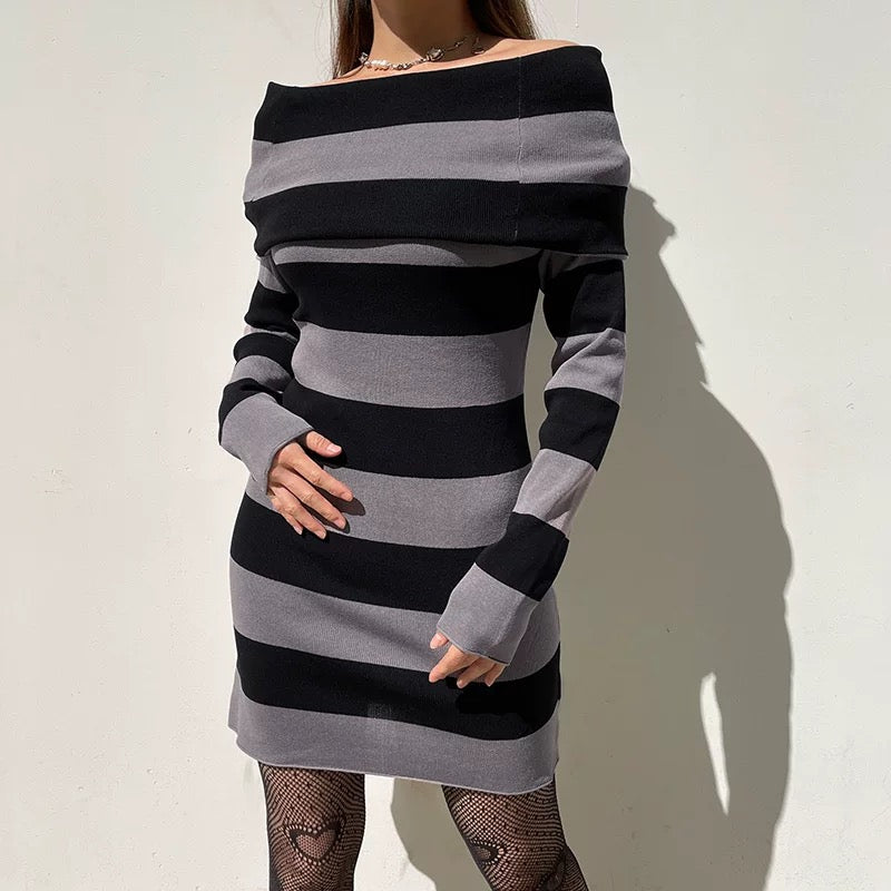 Black and gray striped dress worn by a person on a white background