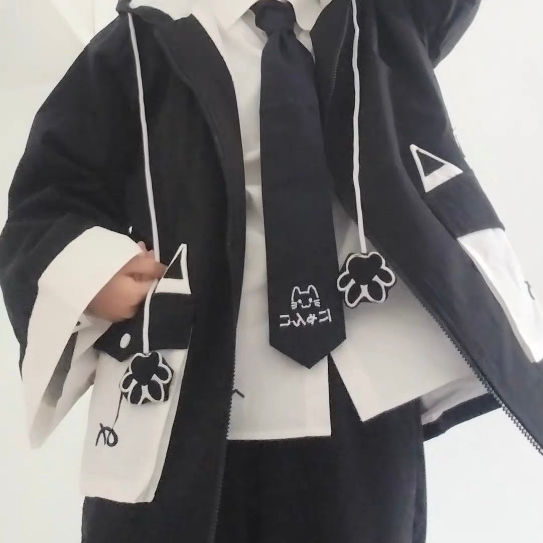 Person wearing a black and white outfit with a tie and accessories on a white background