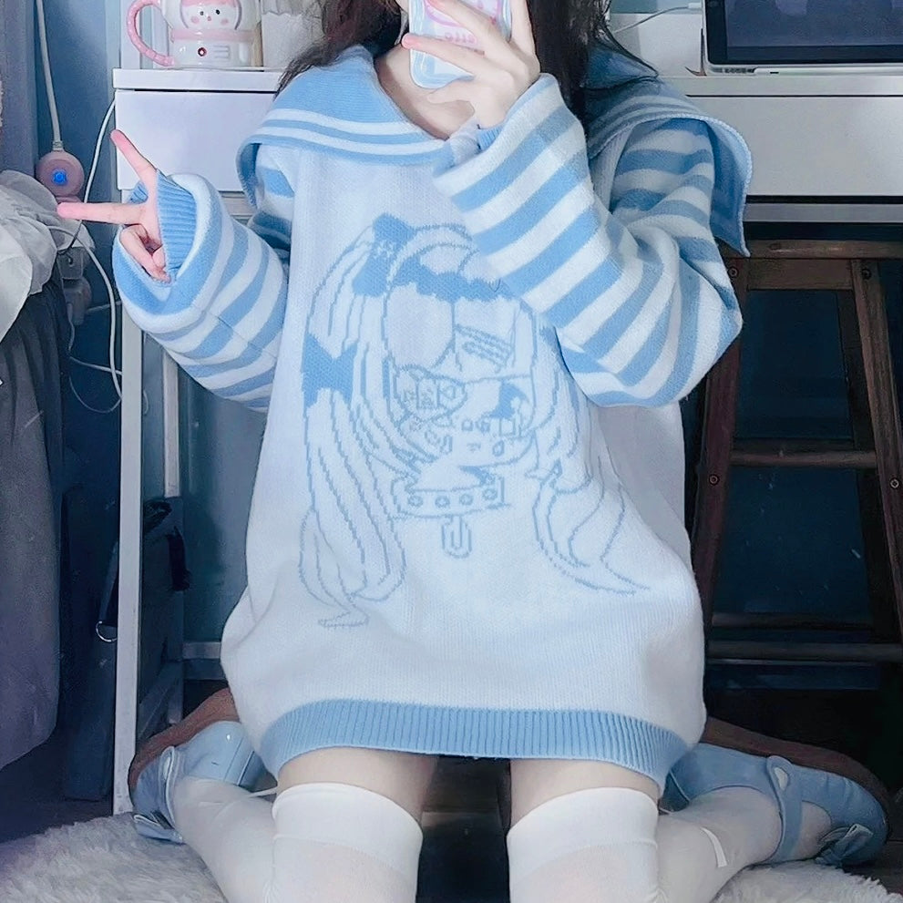 Person wearing a blue and white striped sweater with a graphic design, sitting indoors.