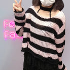 Femboy in pink and black striped distressed crop sweater with black skirt