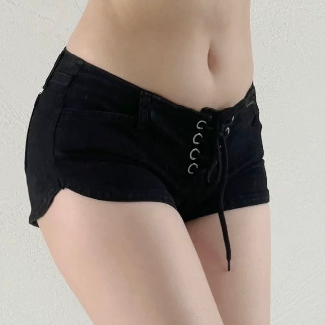Black shorts with lace-up front on a plain background