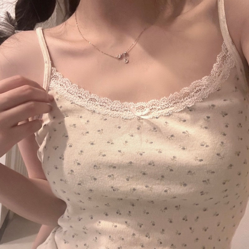 Close-up of a femboy wearing a sweet camisole top with a necklace.