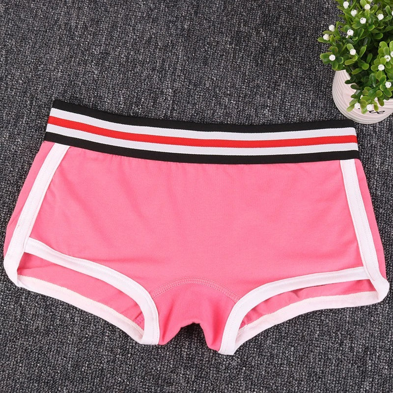 Pink boyshort underwear with a striped waistband on a gray surface.