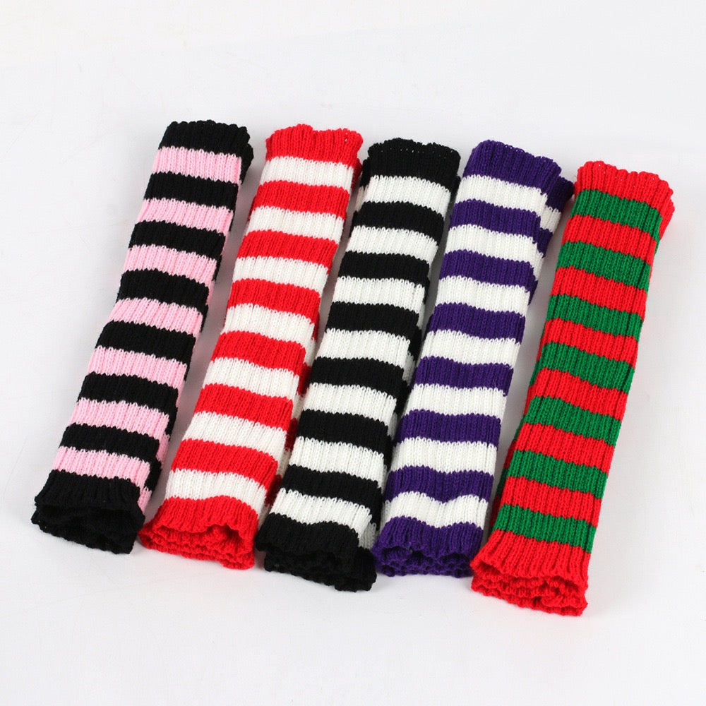 Five pairs of striped arm warmers in different colors on a white background