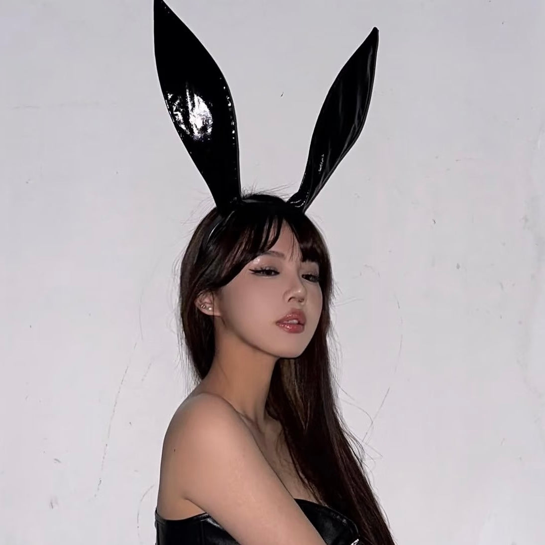 Bunny femboy wear a black leather bunny ear headband