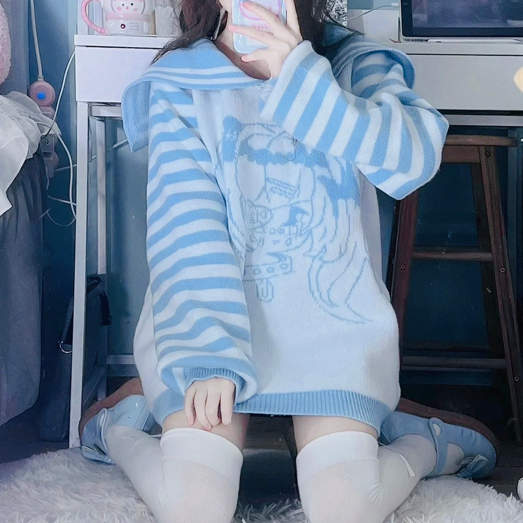 Person wearing a blue and white striped sweater with a graphic design, sitting on a bed.