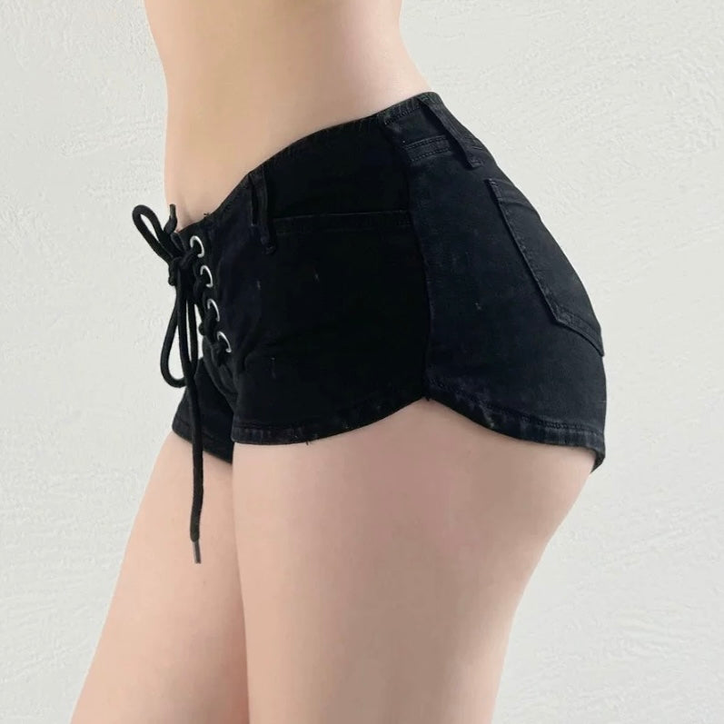 Black denim shorts with lace-up front on a plain background