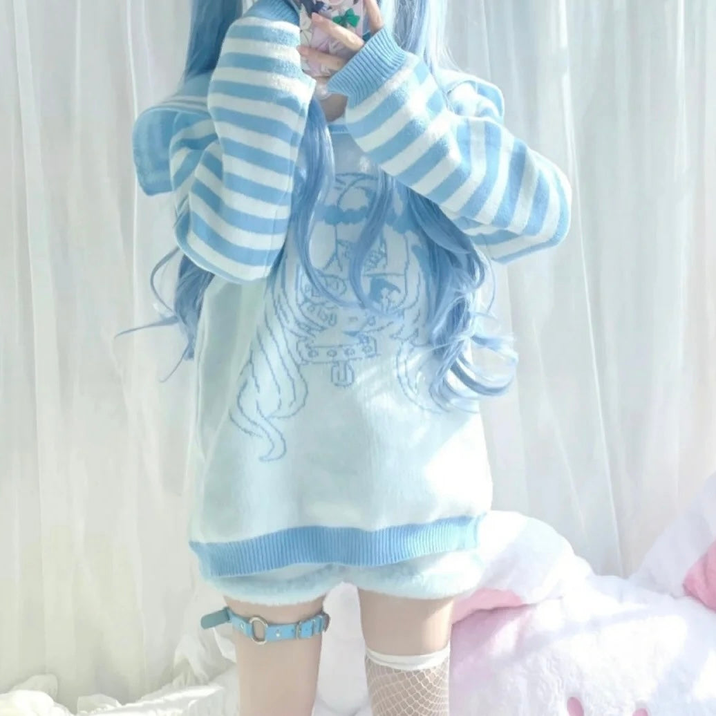 Person wearing a blue and white striped sweater with a graphic design against a white curtain background