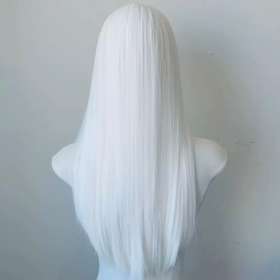 White femboy wig on a mannequin head against a plain background