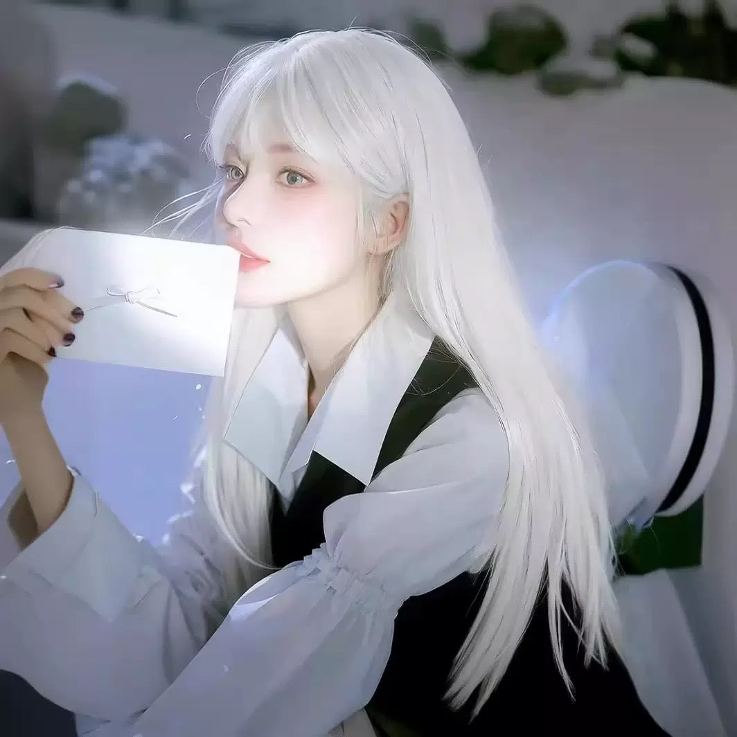 Person with long white hair holding a white object in a blurred indoor setting