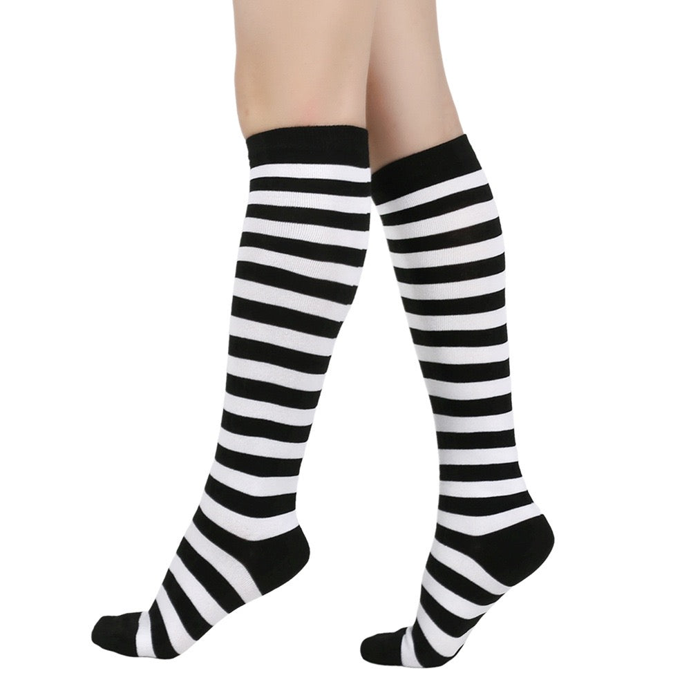 Black and white femboy pin striped knee-high socks on a white background