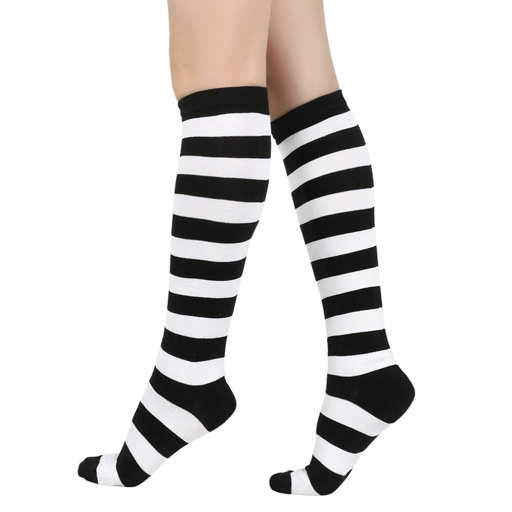 Black and white femboy striped knee-high socks on a white background