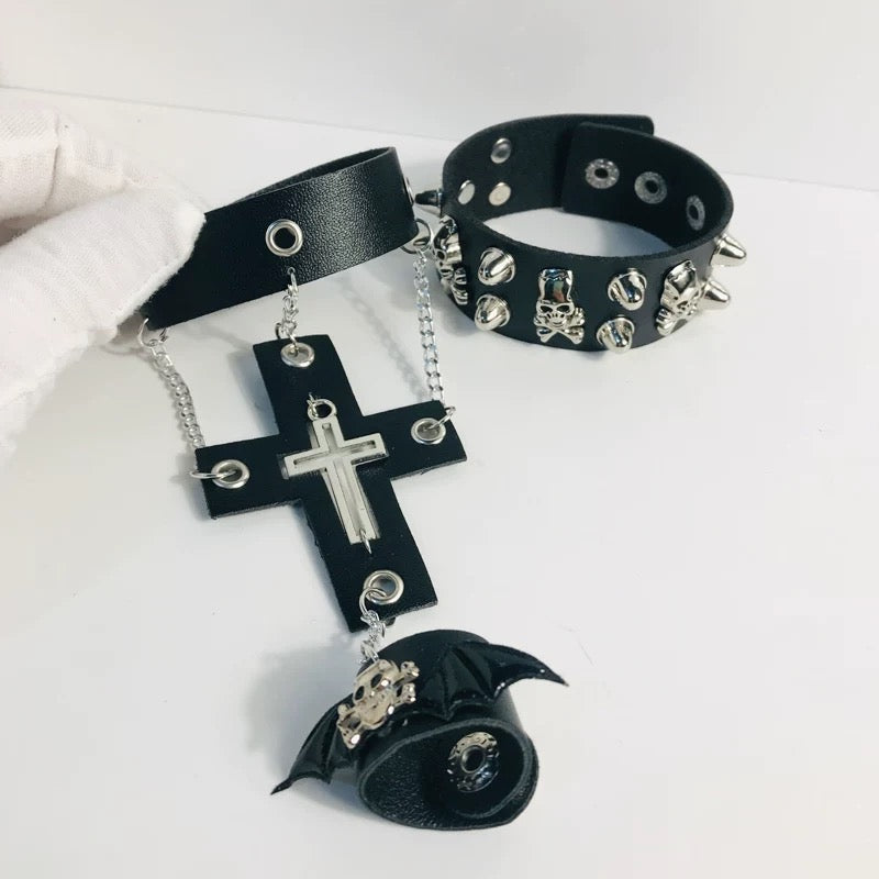 Black leather choker with cross and bat pendant on a white background