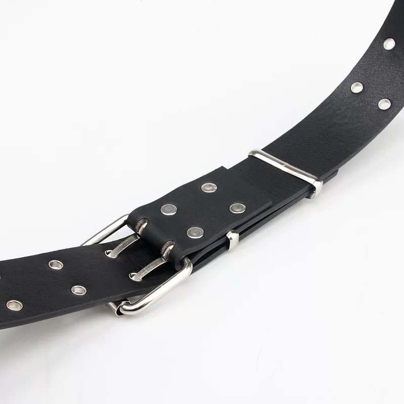 Black leather belt with silver hardware on a white background