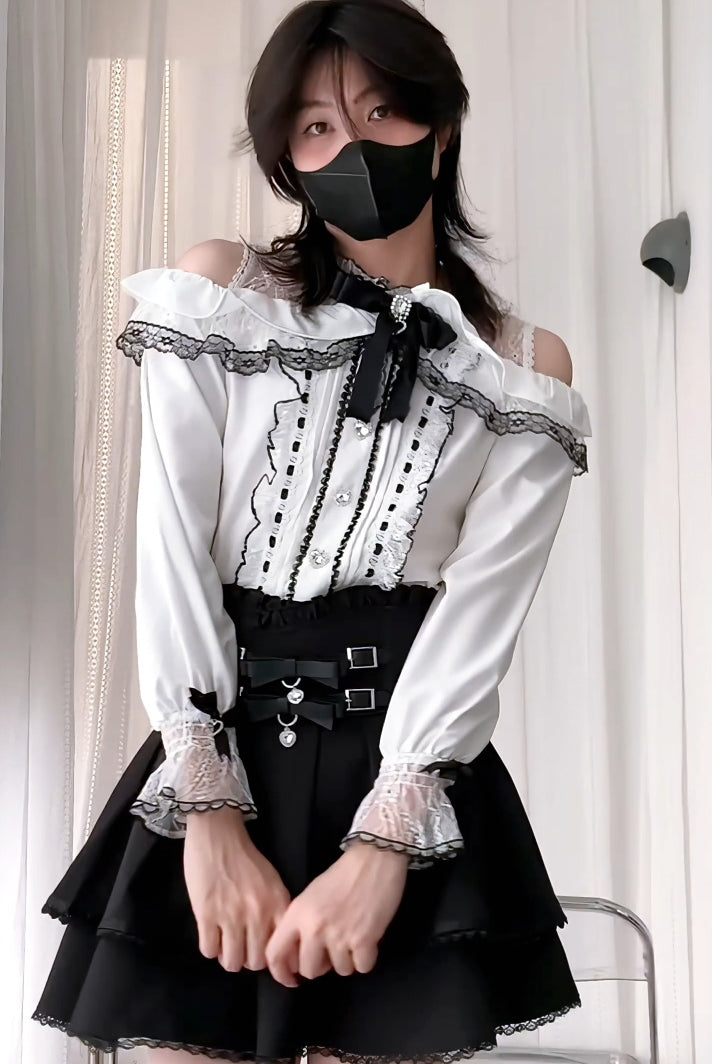 Person wearing a black and white outfit with a black skirt and white top.