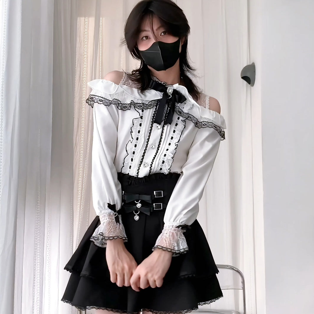 Person wearing a black and white outfit with a black skirt and white top.